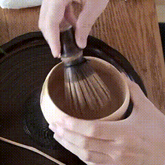 Warming a matcha bowl and softening the bamboo whisk in hot water